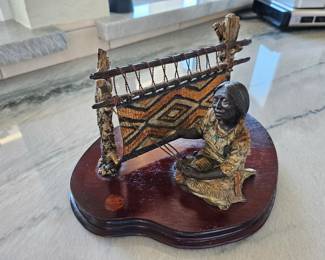 Bronze Indian Weaver sculpture on wood base.  Literally looks like fabric. 