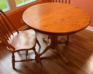 36"d diameter pedestal Oak table with 4 Windsor back chair and one 12" leaf - not shown