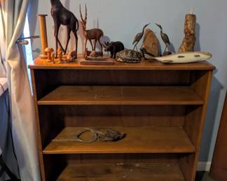 Bookcase and wooden animals figurines