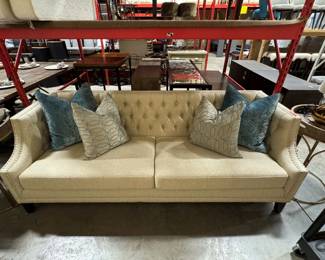 cream tufted curve arm sofa