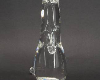 Steuben Glass Mink Figurine with Diamond Inset Eyes. This inquisitive clear glass Mink is shape No. 8334 from Steuben’s menagerie of charming animal figures, and has the special touch of inset diamond eyes. Designed by Lloyd Atkins and introduced in 1976. Etched Steuben signature on bottom and stands 7-1/2 inches H. 