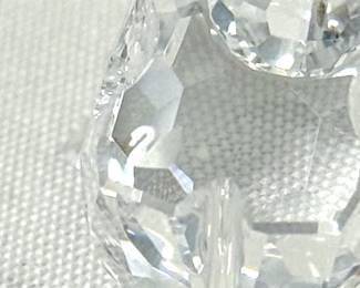 Closeup of Swarovski crystal figurines including Swarovski crystal cobra snake figurine designed by Heinz Tabertshofer, a Swarovski cystal miniature owl figurine, Swarovski crystal snail on vine leaf, a mouse figurine, a Swarovski crystal 2013 Renewal Membership Orchid figurine in clear crystal with a green crystal stem, a Swarovski crystal elephant, and a Swarovski Rooster crystal figurine