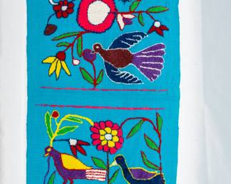 A vibrant, hand-embroidered textile, likely a table runner or wall hanging, Mexican or Peruvian