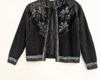A vintage black cardigan sweater from India House, Hong Kong, decorated with black and silver sequins in floral patterns