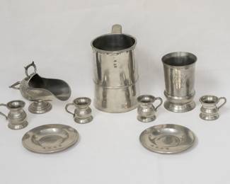 A selection of antique and vintage pewter and silver plated items including a silver-plated sugar scuttle, a antique English pewter measure, also known as a tankard, with quart capacity; a set of four antique pewter quarter gill measure cups, historically used in British pubs and bars for spirits
