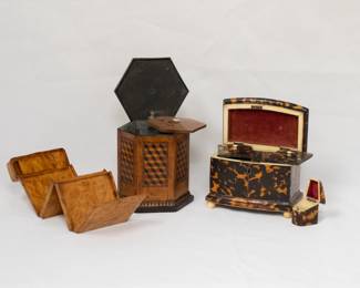 Another view of the marvelous antique carved burled wood cigarette case that expands into two storage areas with a storage compartment for matches or lighter in the top; a 19th century antique English hexagonal tea caddy with hinged lid and featuring a distinctive wooden marquetry inlay design with a tumbling blocks pattern, the interior with another wooden lid over a lined compartment; and a fabulous William IV / early Victorian tortoiseshell locking tea caddy of rectangular form,  the shallow pagoda top opening to twin lidded compartments, on plinth base and ball feet; along with a matching stamp case or needle case.