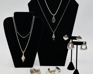 Score some shining silver necklaces, earrings, brooches and bracelets at our warehouse sale- including a Mexico sterling silver conch shell pendant on sterling chain, a signed Beynon sterling silver modernist square brooch, a Mexico sterling silver curved crescent moon brooch, a sterling silver starfish pendant, pair of Mexico sterling silver door knocker earrings, and more! 