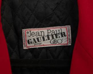 Closeup of vintage 1980s Jean Paul Gaultier red wool safety pins jacket and skirt suit size 42, made in Italy