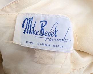 Closeup of the fabulous 1970s vintage Mike Benet Formals white chiffon halter dress with rhinestone clip