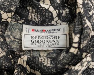 Closeup of vintage Yves Saint Laurent black and white lace silk blouse, made in France