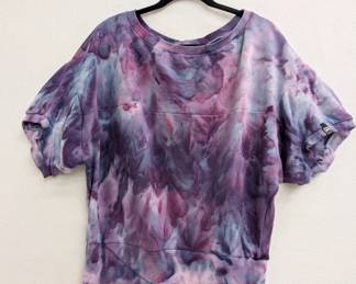 A short sleeved blue, purple and pink tie-dye pullover shirt