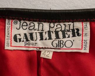 Closeup of vintage 1980s Jean Paul Gaultier red wool safety pins jacket and skirt suit size 42, made in Italy