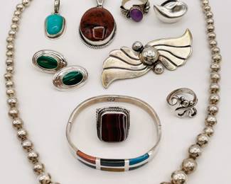 Shimmering silver by skillful artists including a vintage Taxco, Mexico modernist sterling silver brooch featuring an abstract, aerodynamic design with applied domed spheres; a Mexican sterling silver necklace of hand-crafted graduated size round silver beads, A Mexican sterling silver pendant with a polished mahogany obsidian cabochon in rope-style bezel setting, a stylized curving line and spheres silver ring marked "J. M. B." and 1965; and a fantastic sterling silver hinged bracelet inset with different color natural stone pieces, and stamped on the inside with artist name, 925 for sterling, and Taxco, Mexico 