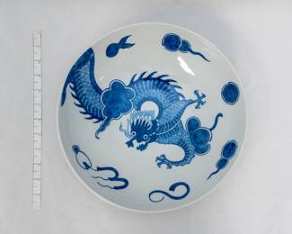A beautiful blue and white porcelain bowl with writhing dragon in clouds, base marked "Blue Dragon design from a porcelain bowl made in England ca. 1765-76 Winterthur Adaptation"
