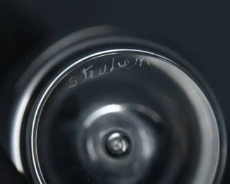 Closeup of Steuben Glass Teardrop Bud Vase Barrett Browning Poem – A solitary air bubble is suspended in the solid glass base of this Steuben iconic vase designed by David Hills and introduced in 1949. Engraved with calligraphy that reads “How do I love thee, let me count the ways" –  a line from Elizabeth Barret Browning’s poem, Sonnet 43, from her Sonnets from the Portuguese. This vase is seen in the Steuben centennial catalog, shape No. 7989J, and measures 8 inches H. Steuben signature on underside of the base. 