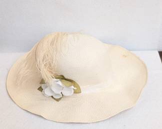 A vintage women's white woven straw hat with wide brim, white feathers and fabric flower. Perfect for your next Kentucky Derby party!