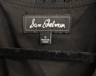 Closeup of the vintage Sam Edelman sleeveless little black dress with gathered shirred waist, V-neck, and handkerchief hem, size S