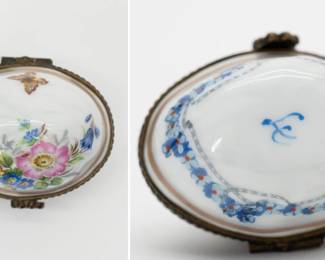 A vintage hand-painted Limoges porcelain trinket box, egg form, with a brass hinge and a floral design with butterfly on the lid and band of blue and red flowers encircling the base