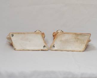 Another view of the antique pair of Bo’ness Scotland ceramic Pekinese dog figurines, made in mirror image, and wearing blue bows at the collar