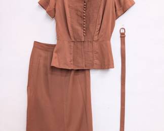 A vintage terracotta color Sherry Kent of Dallas skirt suit with pin tucked short sleeve top, a straight skirt, and matching belt