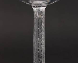 Closeup of six signed Lalique Phalsbourg pattern champagne/tall sherbet glasses, 5 1/2 inches H. Each squared, frosted stem is molded with grape vines. Originally designed under Rene Lalique in 1924, this pattern was made 1924 - 2021, and each glass is etched Lalique France on the underside of the foot in script.   