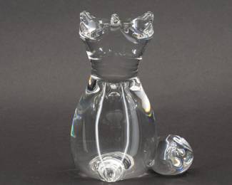 A rare signed Steuben Glass fox figurine from a 1989 design by Lloyd Atkins. This Steuben glass fox model No. 8582 has its pointed nose and ears tilted upward—perhaps as it looks at birds in the sky—while its voluminous tail is wrapped around its side.  Artist initials L D A are next to the diamond point Steuben signature on the base. Size 3-3/4 inches L x 4-1/2 inches W x 6 inches H.