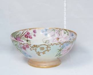A lovely porcelain bowl circa 1898, hand-painted with flowers over a shaded pastel background with gilded scrolls at the rim with an acanthus scroll cartouche containing initials. Signed on the base with "Xmas 1898 E. M. W."   