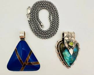 An 18" long sterling silver box belcher chain, and two stylish sterling silver pendants: An arrow-shaped labradorite pendant with exquisite silver detailing and a bezel set green stone, and a triangular blue stone pendant with tigers eye inlay.