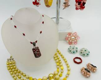 Brightly colored costume jewelry bracelets, necklaces and earrings