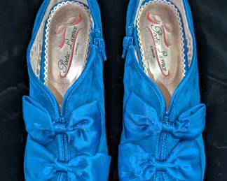 Another view of the pair of Poetic License London high heel blue suede bows open toe shoes, size 7