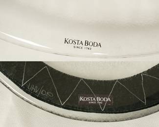 Closeup of the two pieces of hand-painted art glass tableware (platters or plates) from Kosta Boda, designed by Swedish artist Ulrica Hydman-Vallien. Part of the "Kaboka" or "Caramba" series, known for its bold, hand-painted black details and fish motifs. 