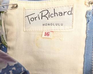 Closeup of the charming summertime seaside dress – vintage Tori Richard Honolulu dress with spaghetti straps, fitted bodice and full skirt, light blue and lilac colors with printed pattern of seashells, coral and starfish; size 16