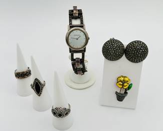 A Judith Jack silver tone and marcasite fashion watch, Judith Jack round domed earrings set with marcasite, and a potted flower brooch; vintage sterling silver and marcasite fashion rings