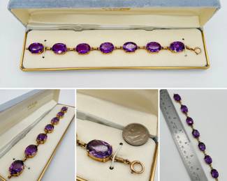 A vintage 14k yellow gold link bracelet featuring seven large oval-cut amethyst gemstones