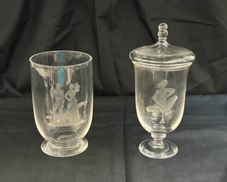 Two rare signed Steuben Glass works of art with hand-engraved designs by renowned sculptor and Steuben designer Sidney Waugh; the first a vase known as "Peasants," inscribed to base with Steuben and the date 1937; the second a covered vase or urn with an Art Deco figure of a seated female nude playing a horn, inscribed on base with Steuben and the date 1936. Sidney Waugh, am award-winning sculptor (with a degree in architecture from MIT), was hired at Steuben Glass in 1933 and served as the company's chief associate designer, and later as artistic director, for three decades. His sculp