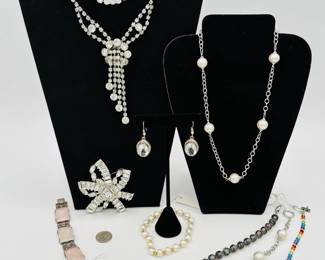 A German sterling silver and rose quartz bracelet, fabulous rhinestone statement necklaces, sterling silver Faux pearl necklace and bracelet, and a magnificent 1960s vintage silver-tone rhinestone stylized ribbon bow brooch with baguette, oval, and chaton clear rhinestones