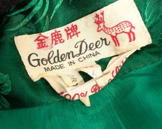 Closeup of the gorgeous deep green brocaded silk robe with finely woven floral pattern, Golden Deer label, made in China