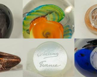 Closeup views of the selection of art glass paperweights and figurines, including a "Small Smew" glass bird from the Iittala Birds collection by Finnish designer Oiva Toikka, a vintage signed Mats Jonasson crystal "Cave Rock Carving" paperweight or sculpture from Målerås, Sweden; and a signed Sabino opalescent glass butterfly figurine