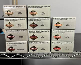 Closeup of the Proto Series 2000 Mather 40' Double Deck Stock Car kits, 50 Ton War Emergency Hopper kits, Mather40' Single Deck Stock Car kits; Proto 1000 Series F3B Powered Locomotive in Burlington livery model kit, F3A Locomotive in Burlington livery model kits in their original boxes