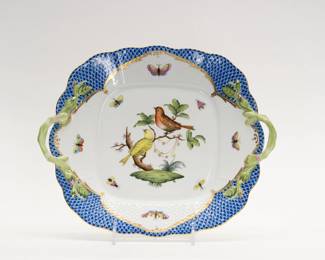 A Herend Porcelain cake or dessert platter vibrantly hand painted in the Rothschild Bird pattern with blue fish scale accents and applied floral handles. Herend stamp and hand painted model number to the underside. 11 1/2 inches L x 9 1/2 inches W.