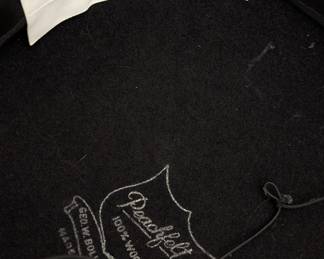 Closeup of the vintage Fabini New York black wool felt hat with a wide brim, ribbon band and netting veil