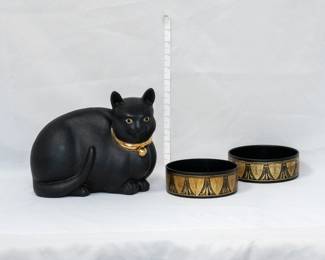 A charmingly dramatic ceramic sculpture of a black cat with a gold collar, signed by artist on the base; and a pair of Victorian papier-mâché wine bottle coasters