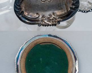 Closeup of silver-plated coaster and ornate sterling silver label on linked chain, reading "Bourbon" and on the reverse, stamped sterling and W for makers mark. 