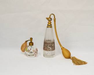 A millefiori glass perfume bottle with a brass atomizer, and an antique 1920-30s Moser crystal perfume bottle with atomizer top and etched metal band of Amazon warriors around the fluted body