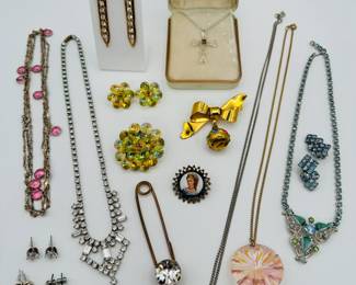 Vintage sparkly rhinestone necklaces and earrings in clear, blues, and pinks; a green and yellow Aurora Borealis bead cluster brooch and earrings set, and a gold tone bow and perfume bottle pendant brooch!