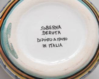 Closeup of hand painted Italian majolica pottery in the Deruta Orvieto Green Rooster pattern – a set of 5 soup or pasta bowls, and a rooster-form creamer pitcher