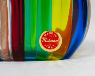 Closeup of one of the two handblown Murano glass perfume bottles with multi-color stripes and glass stoppers