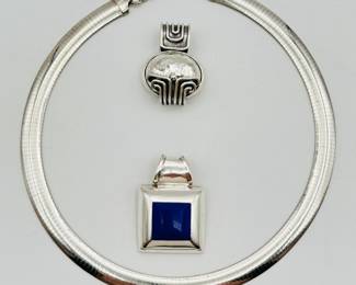 A superb sterling silver Omega collar and two pendants – a 2/8-inch wide omega sterling silver 16" choker with two stunning interchangeable pendants, giving you three distinctive style options. One pendant is a three dimensional geometric tribal inspired pendant, the other a crisp and classic square blue stone inlaid in polished silver.