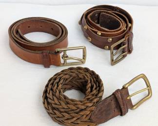A selection of brown leather belts - with brass tone buckles - choose from woven, smooth, and one with brass studs!