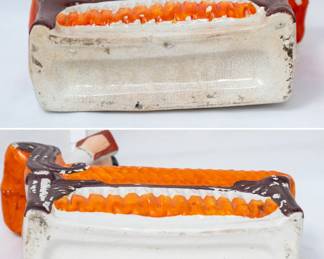 Closeup of a pair of vintage Staffordshire flat back bookends or mantel figurines, of a man and woman each reclining on a chaise longue with a musical instrument while reading a book